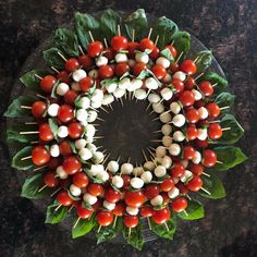 a platter filled with skewered tomatoes and mozzarella