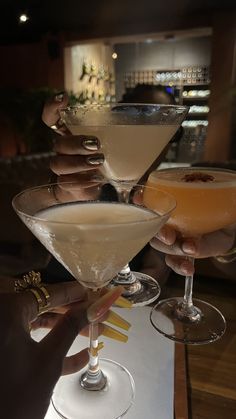 three martinis are being served at a restaurant