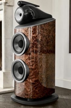 a large speaker sitting on top of a wooden floor