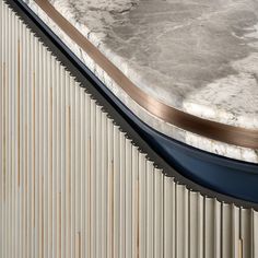 a marble topped table sitting on top of a metal wall