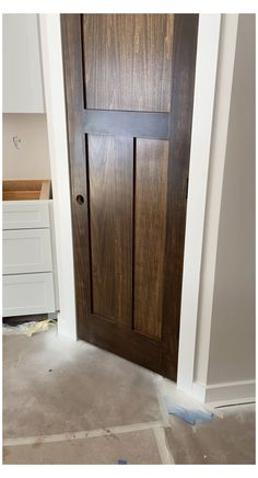 a wooden door is being installed in a room