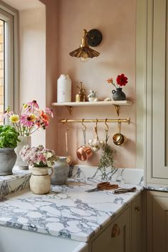 a kitchen with marble counter tops and gold faucets