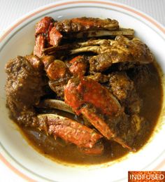 a white plate topped with meat covered in gravy