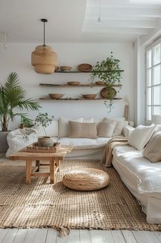 a living room filled with lots of white furniture and plants on top of the shelves