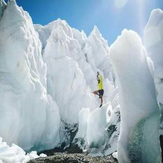 a man standing on top of an ice covered mountain