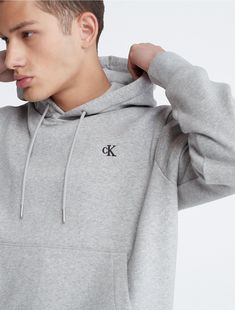 Made from a soft cotton blend, this fleece hoodie offers ultimate comfort for everyday wear. Designed with long sleeves and a kangaroo pocket at the front. Finished with CK monogram logo embroidery at the upper chest.  Material: 80% Cotton, 20% Polyester. Classic Hooded Sweatshirt With Ribbed Cuffs, Classic Long Sleeve Hoodie With Drawstring, Classic Long Sleeve Sweatshirt With Double-lined Hood, Classic Cotton Sweatshirt With Drawstring Hood, Basic Cotton Hoodie With Kangaroo Pocket, Calvin Klein Crew Neck Sweatshirt With Ribbed Cuffs, Calvin Klein Relaxed Fit Sweatshirt For Fall, Classic Hooded Sweatshirt With Drawstring, Basic Cotton Sweatshirt With Kangaroo Pocket