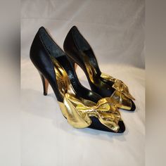 These Vintage Beverly Feldman Fabric Heels Have A Beautiful Gold Bow Across The Toe. It's Such A Fun Heel That Can Be Worn With Anything. New, Never Worn, In Great Vintage Condition. Small Scuff On The Right Bow. Ask Me Any Questions. Size 7.5 Satin-Like Fabric Heel, Gold Leather Bow 3.5" Heel. Black And Gold Retro Court Shoes With 4-inch Heel For Party, Retro Closed Toe Heels For Party, Retro Court Shoes For Party, Retro Heels For Party, Retro Pointed Toe Court Shoes For Party, Retro Round Toe Evening Heels, Retro Round Toe Heels For Evening, Retro Closed Toe Court Shoes For Evening, Vintage High Heel Court Shoes For Party