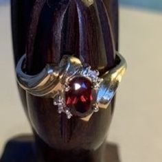 This beautiful vintage art nouveau ring is the perfect gift for Mom, Wife, Sister, Girlfriend or Daughter. The 10K gold rings holds an oval garnet with tiny diamond look chips on either side.  Features: 10K Gold Vintage pre-owned ring Garnet colored oval stone Diamond type chips - 2 per side January Birthstone Garnets are said to help prevent nightmares This ring would make a wonderful gift for Christmas, Birthday, Valentine's Day or Anniversary.  Free shipping  Returns accepted within 14 days (see policy) Gold Vintage Ring, Art Nouveau Ring, 10k Gold Ring, Colored Stone Rings, Colored Stone, Tiny Diamond, Art Nouveau Style, Red Band, Gold Gift