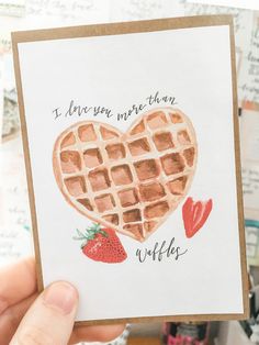 someone is holding up a card with waffles on it