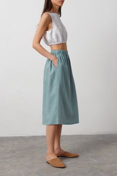 "ELLE is a casual linen midi skirt. DETAILS - Midi length - Elastic waist - 100% lightweight European linen fabric - Cut and sewn to order just for you in our studio COLOR - Dark Turqouise, you can also choose other colors above SIZING & FIT - Fits true to size - Model is 5'9.5\" / 177cm, wearing a size XS CARE FOR LINEN - Machine wash up to 30ºC/86ºF gentle cycle - Lay flat to dry or tumble dry low - Warm iron if needed - Do not bleach SIZE GUIDE Size conversion guide Size XS (US 0-2, IT 36-38, UK 4-6, Japan 3-5, France 32-34) Size S (US 4-6, IT 40-42, UK 8-10, Japan 7-9, France 36-38) Size M (US 8-10, IT 44-46, UK 12-14, Japan 11-13, France 40-42) Size L (US 12-14, IT 48-50, UK 16-18, Japan 15-17, France 44-46) Size XL (US 16-18, IT 52, UK 20-22, Japan 19, France 48) Body measurements gu Cotton Midi Skirt Outfit Summer, Summer Bottoms With Pockets, Midi Length, Casual Linen Gathered Skirt, Casual Linen Gathered Skirt Bottoms, Summer Linen Midi-length Bottoms, Casual Linen Maxi Skirt, Casual Linen Skirt, Linen Skirt With Elastic Waistband For Day Out, Casual Linen Summer Skirt