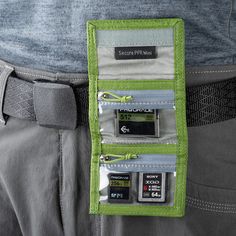 The highland green Mini Secure Pixel Pocket Rocket Memory Card Wallet from Think Tank Photo holds 4 CF or CFexpress cards, 6 SD cards, or multiple microSD cards. Its folding design features a secure hook-and-loop closure and clear zippered pockets for easy card identification and security. Sized to fit in your pocket or bag, it includes a removable security lanyard and belt attachment for convenient transport. Made from durable, weather-treated double-ripstop material, this wallet protects your cards from the elements. Multifunctional Green Rectangular Travel Accessories, Green Travel Card Holder With Interior Slots, Functional Green Rectangular Cases, Functional Green Rectangular Case, Green Trifold Travel Wallet, Functional Green Travel Accessories, Functional Green Rectangular Organizer, Green Rectangular Functional Organizer, Green Trifold Wallet With Card Slots For Everyday Use