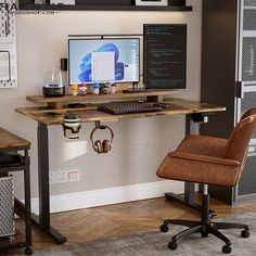 a desk with a computer and headphones sitting on top of it next to a chair