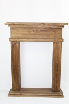 a small wooden fireplace surround made out of wood planks and plinted with white background