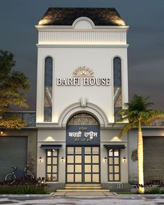 an image of a building that is lit up at night with palm trees in the foreground