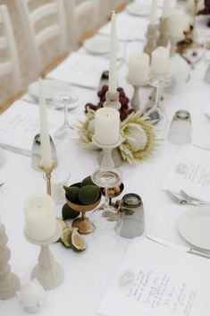 the table is set with candles and place settings