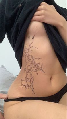 a woman with a tattoo on her stomach