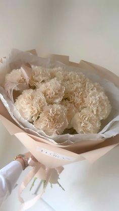 a person holding a bouquet of white flowers