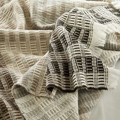 Specialist weaving techniques are utilized to stunning effect in this stylish interior throw. A grid of neutral yarns creates a contemporary cross linear effect with depth, texture and warmth. Featuring shades of grey, white, chocolate and stone, this fine merino wool and cotton blend throw is finished with a fringed. Product information:Size: 51x71in/130x180cm Fabric: Merino Wool, Cotton, AcrylicCare Instructions: Dry clean onlyComposition: 20% Merino Wool, 40% Cotton, 40% Acrylic Contemporary Cross, Decorative Throws Blanket, White Throw Blanket, Stylish Interior, Sewing Table, Woven Throw, Designer Throws, Luminaire Design, Fine Linens