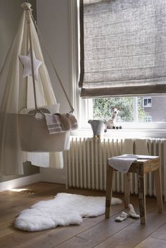 a white radiator sitting next to a window in a room filled with furniture