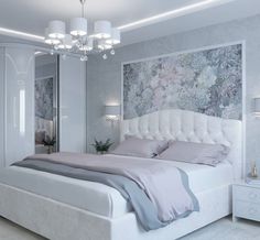 a white bed sitting under a chandelier next to a dresser with drawers and lamps