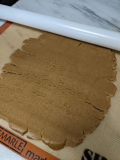 a piece of brown cake sitting on top of a counter next to a white spatula