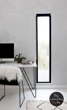 a white desk with a computer on top of it next to a black and white chair