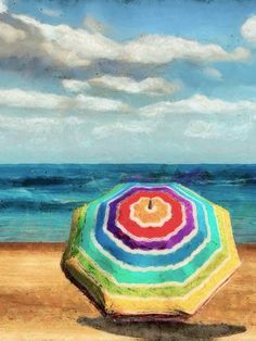 an umbrella sitting on top of a sandy beach next to the ocean under a cloudy blue sky