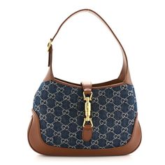 This is an authentic GUCCI New Denim GG Monogram Calfskin Small Jackie 1961 Hobo in Blue Tea Cuir. This Gucci hobo is beautifully crafted of monogrammed denim. The bag features tan calfskin leather trim including the adjustable looping shoulder strap, base, corners, and crossover strap. The crossover strap is secured with a gold-tone piston lock and opens to an ecru fabric interior with a zipper pocket. It can be carried by hand, in the crook of the arm, or over the shoulder with the adjustable Gucci Denim Bag, Blue Gucci Shoulder Bag For Everyday Use, Gucci Jackie Hobo Bag Vintage, Luxury Gucci Hobo Shoulder Bag, Gucci Formal Hobo Bag With Gold-tone Hardware, Gucci Hobo Bag, Gucci Hobo Shoulder Bag With Gold-tone Hardware, Gucci Jeans, Gucci Denim