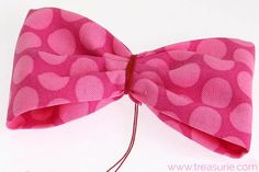 a pink bow tie with hearts on it