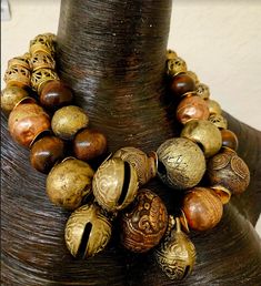 Look at how stunning this African oversized beaded tribal statement necklace is! The components include Yoruba brass beads (with imperfections), Ethiopian copper beads, a Tibetan copper repousse accent bead, chocolate brown round wood beads, burnished gold tone metal wavy spacers, rhinestone rondelles and African glass hand painted beads. Despite the heavy look, this is actually quite lightweight as most of the metal beads are hollow. Adjusts from 19-21" and I can add additional chain links free Large Bronze Bohemian Beads, Bohemian Large Bronze Beads, Artisan Bronze Beaded Necklaces With Large Beads, Bronze Artisan Beaded Necklace With Large Beads, Artisan Beaded Necklaces With Large Bronze Beads, Traditional Bronze Necklaces With Large Beads, Artisan Beaded Necklace With Large Bronze Beads, Bronze Bohemian Necklace With Large Beads, Bohemian Bronze Necklace With Large Beads