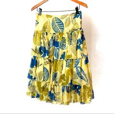 ______ Bay Silk Tiered Skirt (Searching For Original Brand Name Will List When Found.) 100% Silk 3tiered Skirt Bright Yellow/Blue Leafy Floral Print Each Tier Is Attached Separately To Liner Tiers Have A Finished Hem But Raw Edge Where They Attach Invisible Side Zipper Plus Hook And Eye Perfect Condition - Never Worn Length - Waist To Hem - 27” Waist - 22” Side To Side (Total 44”) Yellow Tiered Vacation Skirt, Yellow Tiered Skirt For Vacation, Yellow Ruffled Long Skirt, Yellow Ruffled Skirt For The Beach, Yellow Tiered Beach Skirt, Yellow Ruffled Beach Skirt, Yellow Relaxed Tiered Skirt, Green Tiered Beach Skirt, Yellow Ruffled Skirt For Beach