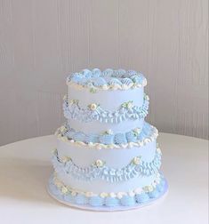 a three tiered blue and white wedding cake