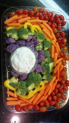 a platter filled with carrots, broccoli and other vegetables