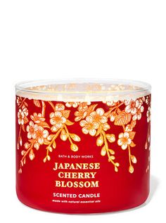 japanese cherry blossom scented candle in a red glass container with gold foiling on the lid