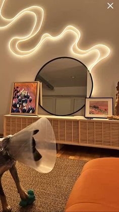 a living room filled with furniture and a mirror on top of a wooden dresser next to a wall