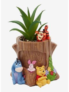 a potted plant with winnie the pooh figurines