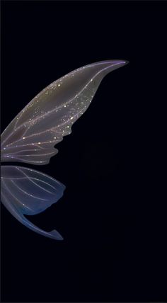 a large white butterfly flying through the night sky