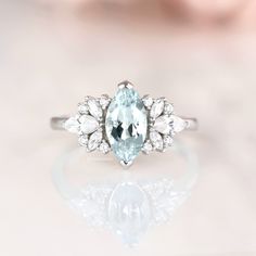 Gorgeous Vintage Inspired Aquamarine Ring ►Made of solid sterling silver with a rhodium finish (925) ►Accented with simulated diamonds (CZ) ►Average band width: 1.8 mm Center Stone: Aquamarine Color: Blue Shape: Marquise Gem size: 5.0 x 10.0 mm Carat Weight: 1 ct. (approx.) Gemstone creation: 100% Natural Hardness: 8-8.5 ✓ 100% Nickel-Free ✓ Comfort Fit ✓ Free Ring Box ✓ Free USA Shipping ✓ Ready to ship next business day *All listing photos and ring design are subject to copyright. *All rights Aquamarine Wedding Diamond Ring With Halo Setting, Wedding Diamond Ring With Aquamarine Halo Setting, Aquamarine Crystal Wedding Ring With Prong Setting, Oval Aquamarine Crystal Wedding Ring, Aquamarine Crystal Ring With Prong Setting For Wedding, Aquamarine Ring With Halo Setting For Anniversary, Oval Aquamarine Wedding Ring, White Gold Aquamarine Rings For Wedding, Classic Aquamarine Rings With Accent Stones