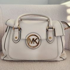 *Brand New & Never Worn* - Original Tags W/ Dustbag Included. White Michael Kors Satchel Bag In The Color "Vanilla". Leather Material With Gold Hardware. Very Spacious With Multiple Pockets And Compartments And A Long Strap To Be Worn As A Cross Body. Dimensions: L - 12" H - 8" W - 6.5" Cream Shoulder Bag With Branded Hardware And Double Handle, Cream Shoulder Bag With Branded Hardware, Michael Kors Beige Satchel With Detachable Handle, Michael Kors Cream Shoulder Bag With Detachable Handle, Michael Kors Cream Satchel Shoulder Bag, Michael Kors Cream Bag With Adjustable Strap, Cream Satchel With Gold-tone Hardware For Errands, Cream Bag With Branded Hardware And Double Handle, Chic Cream Satchel With Branded Hardware