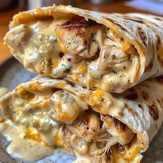 two quesadillas stacked on top of each other with cheese and chicken in them