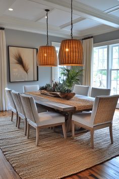 a dining room table with chairs and a potted plant on top of the table