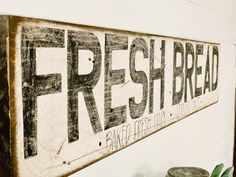 there is a sign that says fresh bread on the wall