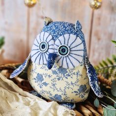 a blue and white owl sitting on top of a basket