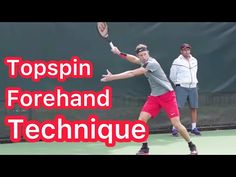 a man swinging a tennis racquet on top of a tennis court in front of two men