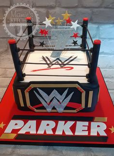 a cake made to look like a wrestling ring with stars around it and the word parker on top