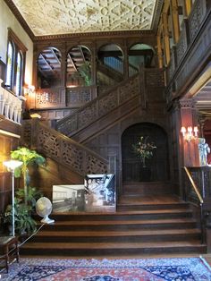 an ornate wooden staircase leading up to the second floor