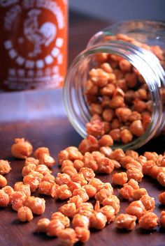 some nuts are sitting on a table next to a jar