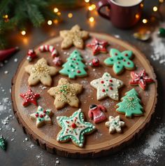 decorated cookies sitting on top of a wooden platter next to a cup of coffee