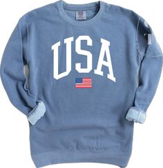 Cotton Long Sleeve Top For 4th Of July, Long Sleeve Cotton Tops For 4th Of July, Relaxed Fit Graphic Print Sweatshirt For 4th Of July, White Crew Neck Sweatshirt For 4th Of July, Long Sleeve Relaxed Fit T-shirt For 4th Of July, Sporty Cotton Tops With American Flag Print, 4th Of July Graphic Print Crew Neck Sweatshirt, Patriotic Crew Neck Sweatshirt With Graphic Print, Patriotic Long Sleeve T-shirt With American Flag Print