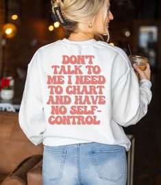 a woman wearing a sweatshirt that says don't talk to me i need to chart and have no self control